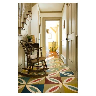 Hallway in colonial home with colorful wooden floor
