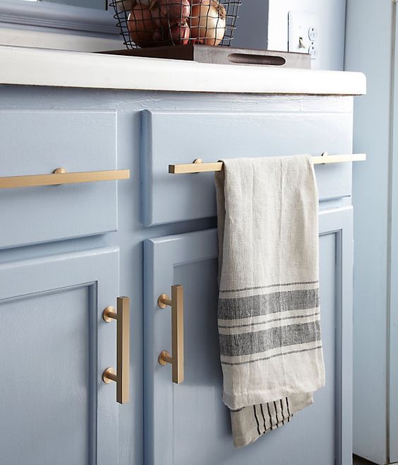 Small NYC rental apartment kitchen makeover. #NYC #apartment #smallspaces. Bonus Solution: Working Hardware Megan added sleek, brushed-brass cabinet pulls to give the remaining cabinet fronts an upgrade. For the two nonworking drawers that front the sink, she fitted two extra-long pulls, and now I have a great place to hang dish towels.