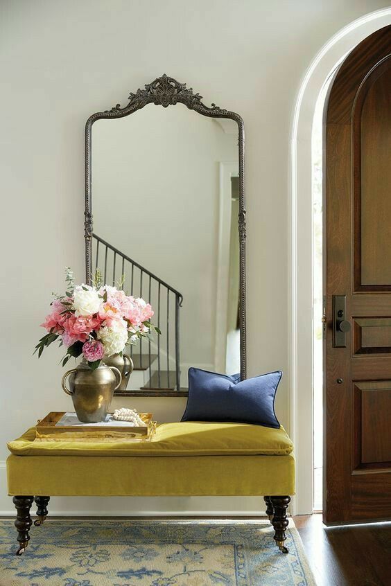 Ornate mirror with simple decor in the entry