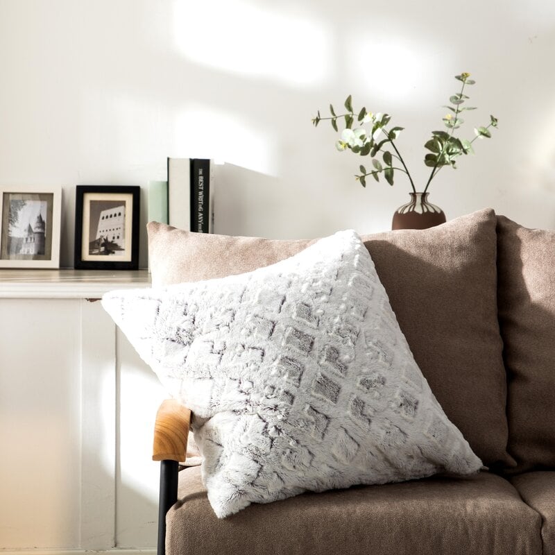 chocolate brown sofa with throw pillows