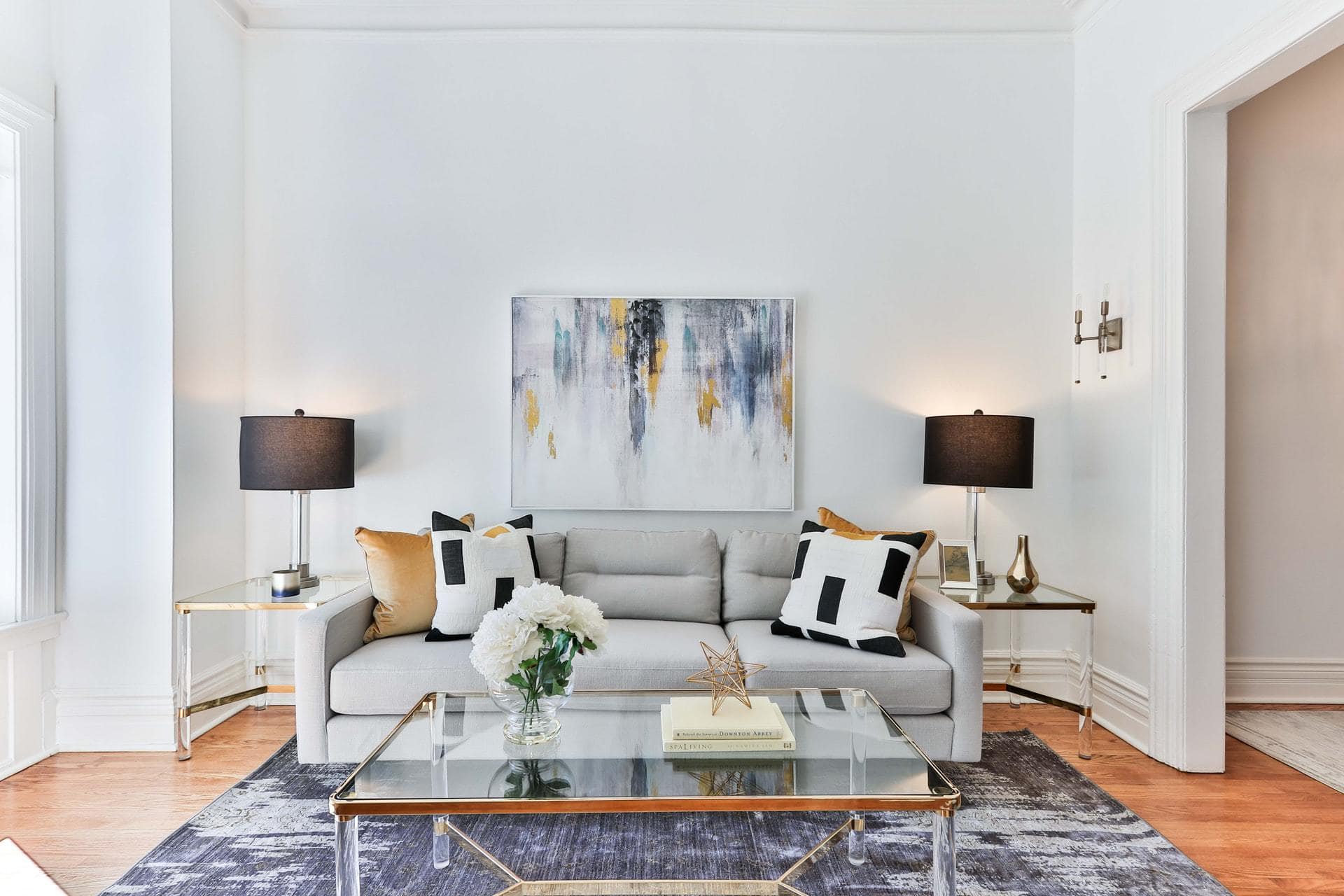 Black, White and Gold Throw Pillows on a Light Grey Sofa