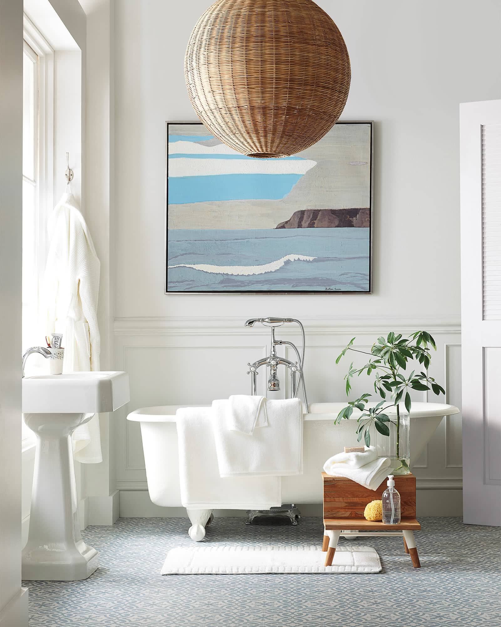 A White Bathroom with Blue and Grey Artwork