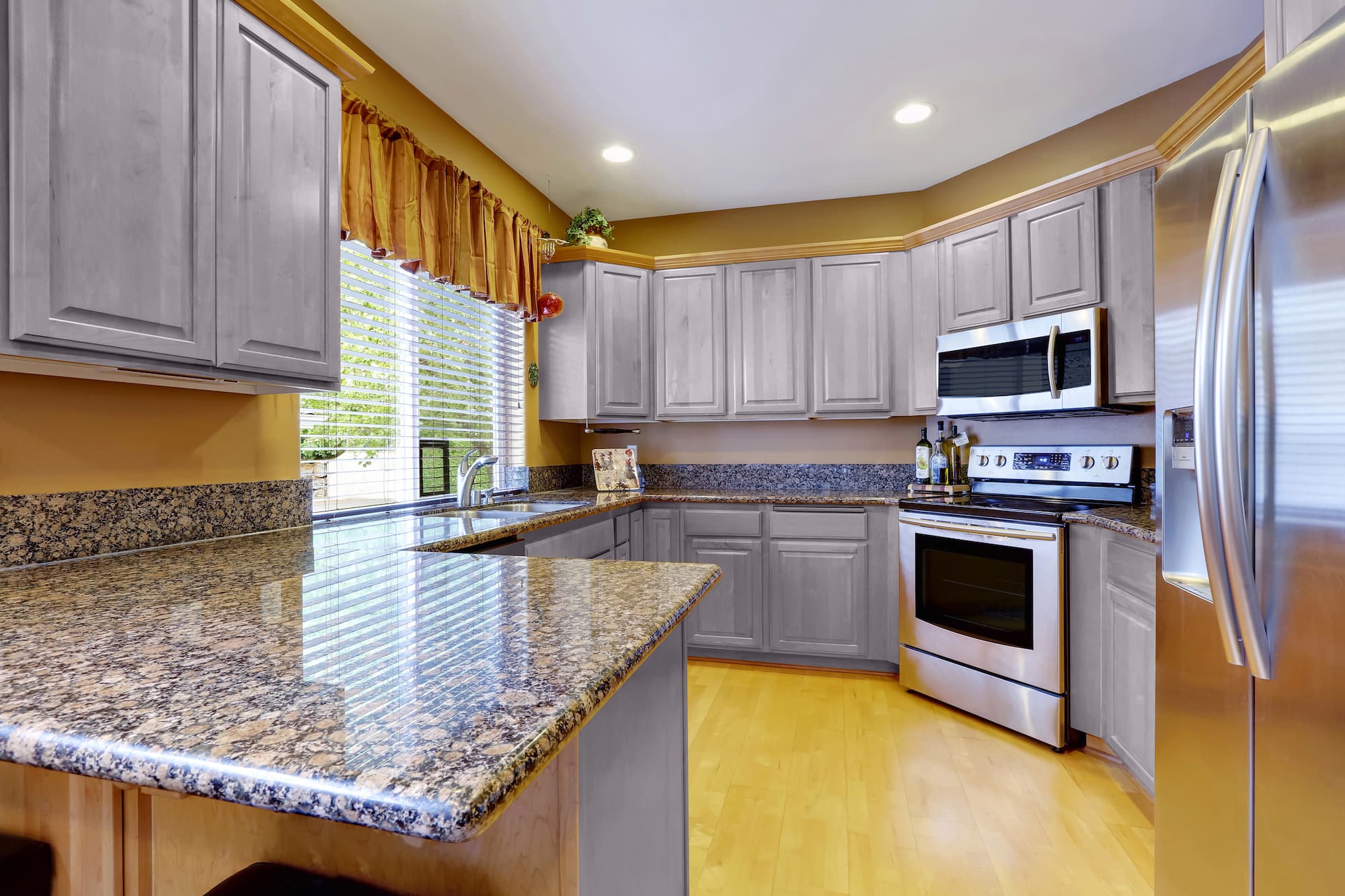 grey granite countertops with brown cabinets