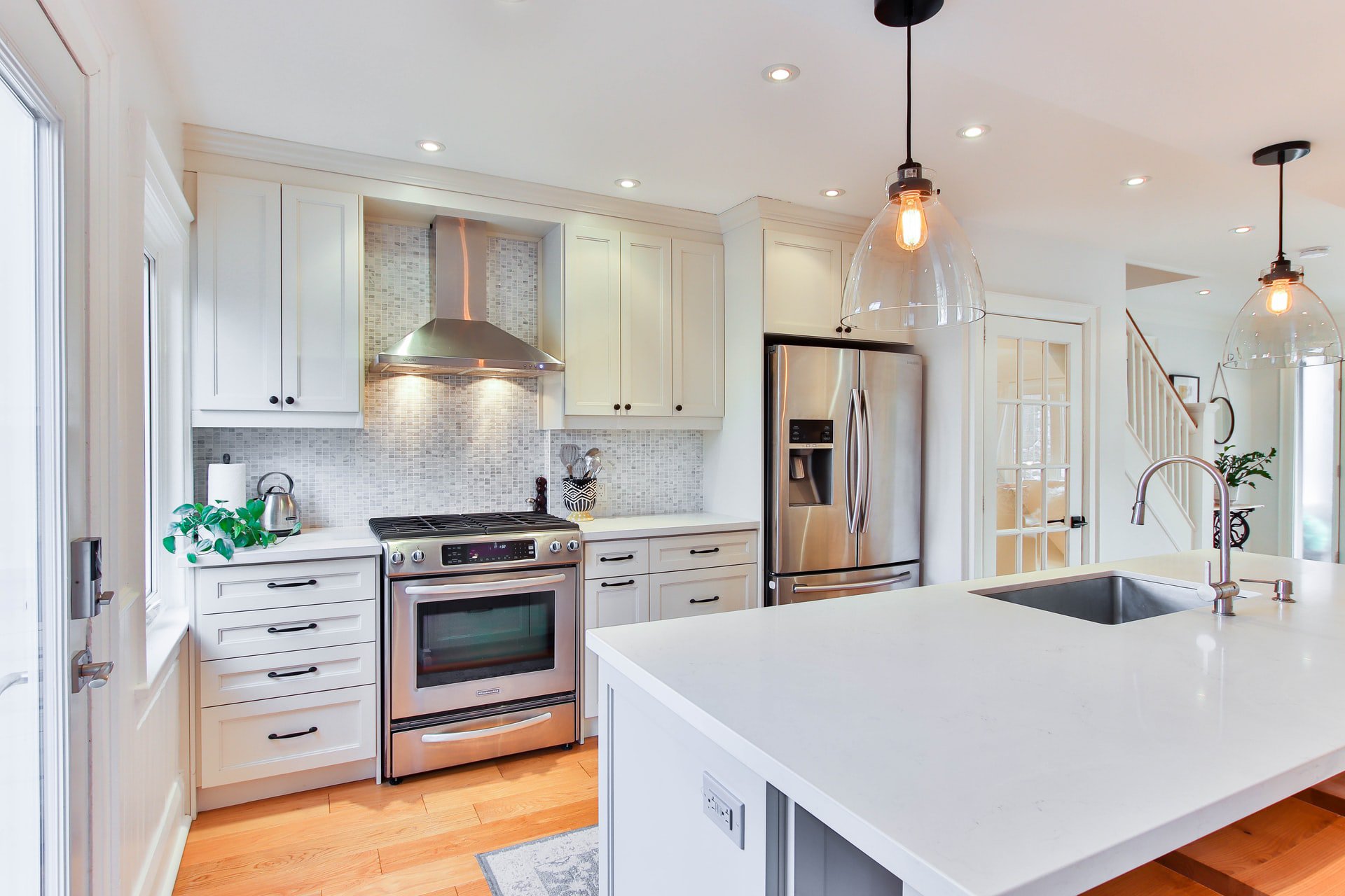 2. White Cabinets with Warm Wood Floors