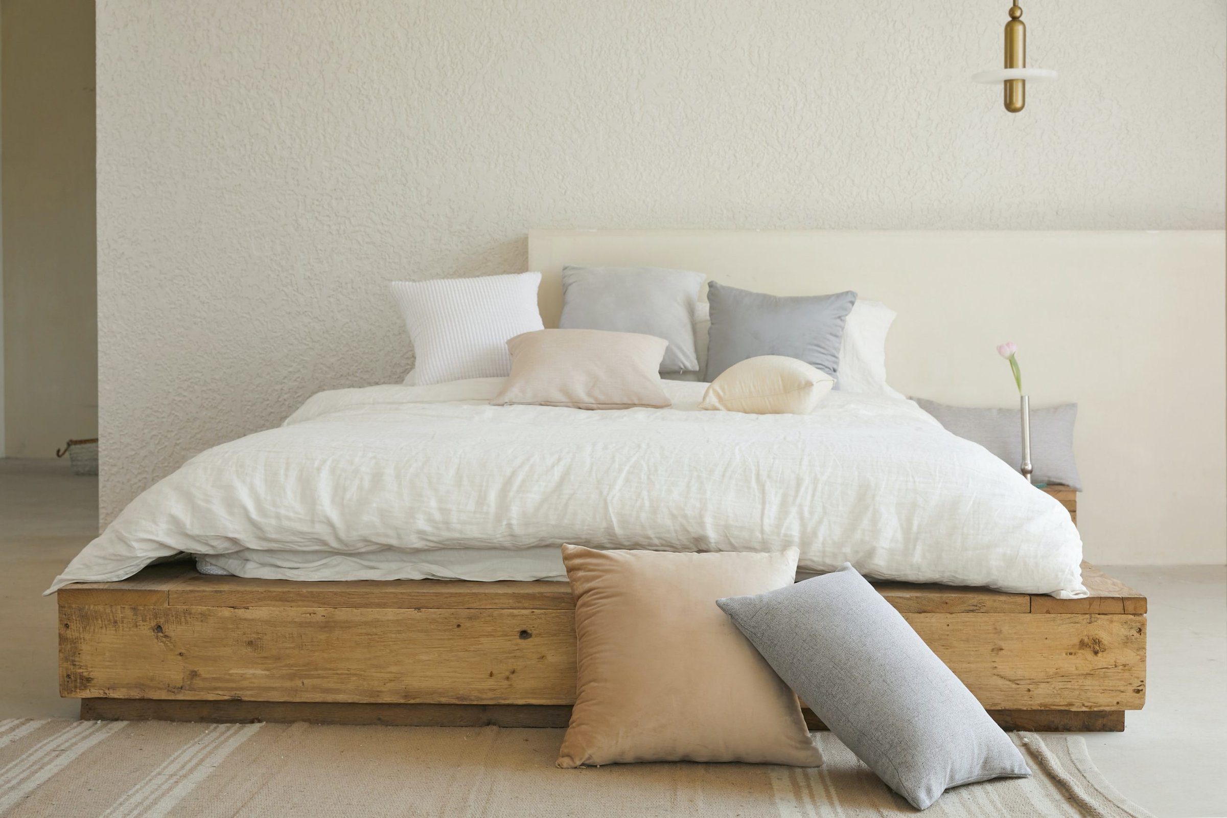  Gray and Beige Pillows on Neutral Bed scaled